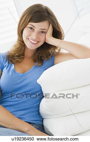 Woman sitting in living room View Large Photo Image Stock Image - Woman sitting in living room. Fotosearch