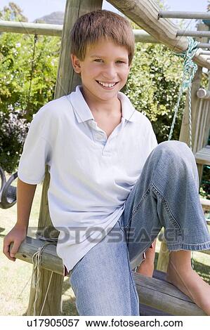 Stock Photo - Young boy at a playground smiling. Fotosearch