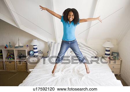 Young Girl Jumping On Her Bed View Large Photo Image Stock Image - Young Girl Jumping On Her Bed. Fotosearch