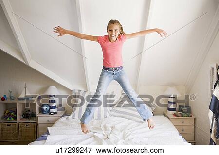 Young Girl Jumping On Her Bed View Large Photo Image Stock Photo - Young Girl Jumping On Her Bed. Fotosearch