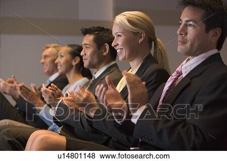 Five businesspeople applauding and smiling in presentation room View Large Photo Image Stock Photo - Five businesspeople applauding and smiling in presentation room. Fotosearch