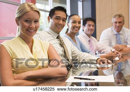 Five businesspeople at boardroom table smiling View Large Photo Image Stock Photography - Five businesspeople at boardroom table smiling. Fotosearch