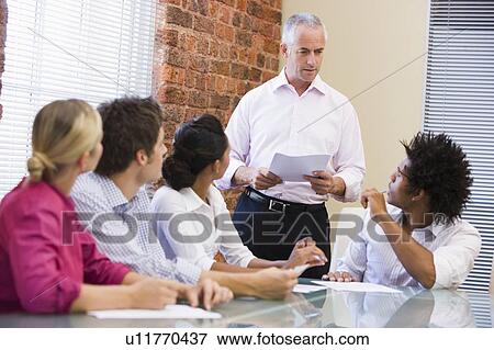 Five businesspeople in boardroom meeting View Large Photo Image Stock Photo - Five businesspeople in boardroom meeting. Fotosearch