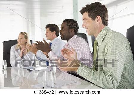 Four businesspeople in a boardroom applauding View Large Photo Image Stock Image - Four businesspeople in a boardroom applauding. Fotosearch