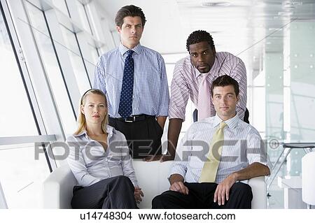 Four businesspeople in office lobby View Large Photo Image Picture - Four businesspeople in office lobby. Fotosearch