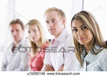 Four businesspeople sitting indoors View Large Photo Image Stock Photo - Four businesspeople sitting indoors. Fotosearch