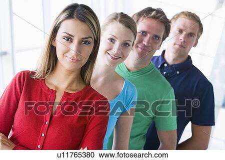 Four people standing in corridor smiling View Large Photo Image Stock Image - Four people standing in corridor smiling. Fotosearch