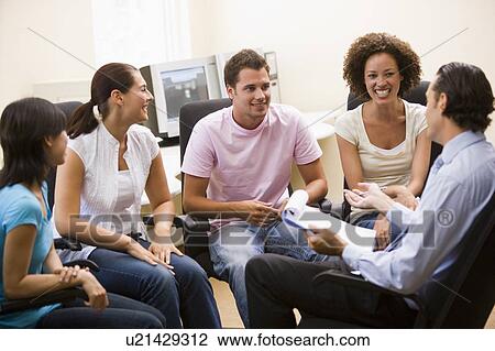 Man giving lecture to four people in computer room View Large Photo Image Stock Image - Man giving lecture to four people in computer room. Fotosearch