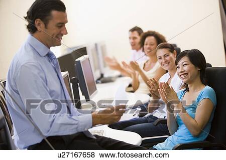 Man with clipboard giving lecture in applauding computer class View Large Photo Image Stock Photo - Man with clipboard giving lecture in applauding computer class. Fotosearch