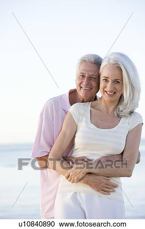 Couple at the beach embracing and smiling View Large Photo Image Stock Image - Couple at the beach embracing and smiling. Fotosearch