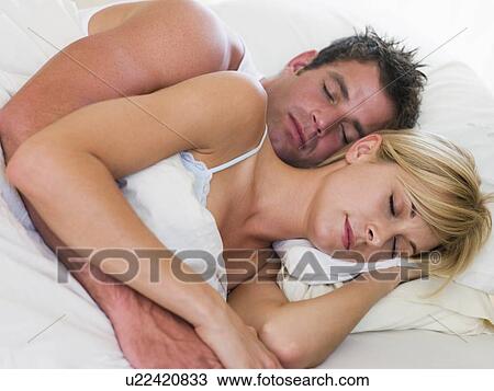 Couple lying in bed sleeping View Large Photo Image Stock Image - Couple lying in bed sleeping. Fotosearch