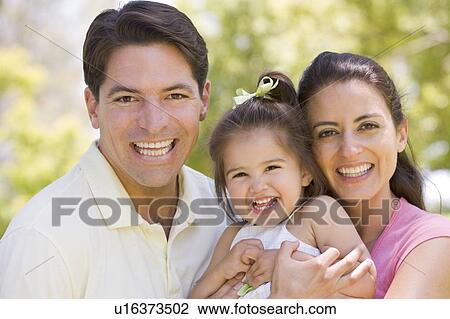 Family standing outdoors smiling View Large Photo Image Stock Image - Family standing outdoors smiling. Fotosearch