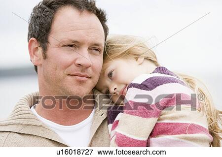Father holding daughter at beach View Large Photo Image Stock Photo - Father holding daughter at beach. Fotosearch
