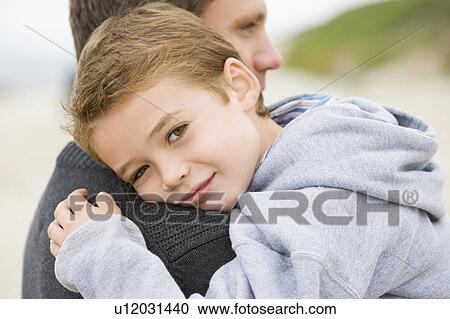 Father holding son at beach View Large Photo Image Stock Image - Father holding son at beach. Fotosearch