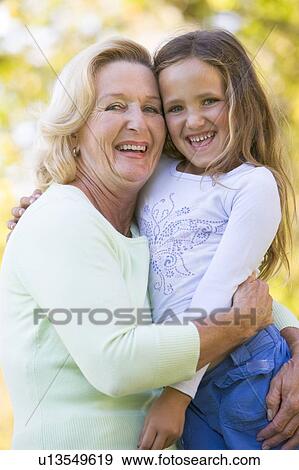 Grandmother and granddaughter outdoors and smiling View Large Photo Image Stock Photo - Grandmother and granddaughter outdoors and smiling. Fotosearch