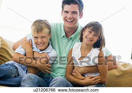 Man and two young children in living room smiling View Large Photo Image Stock Photograph - Man and two young children in living room smiling. Fotosearch