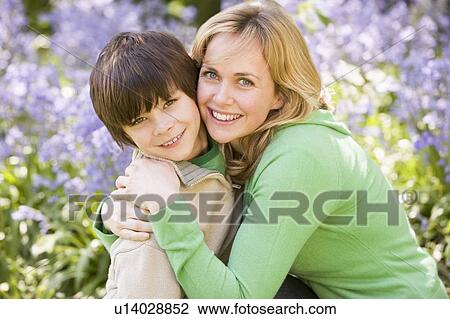 Mother and son outdoors embracing and smiling View Large Photo Image Stock Image - Mother and son outdoors embracing and smiling. Fotosearch