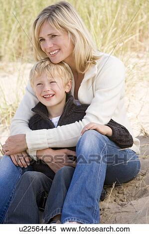 Mother and son sitting on beach smiling View Large Photo Image Stock Photography - Mother and son sitting on beach smiling. Fotosearch