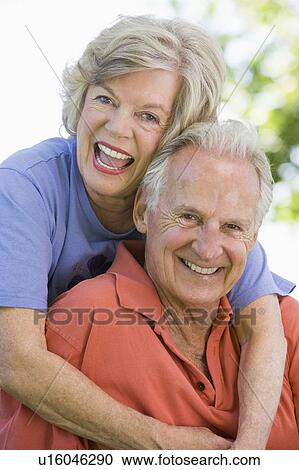 Stock Image - Senior couple sitting outdoors. Fotosearch
