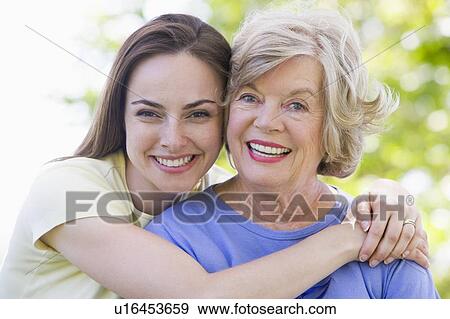 Two women outdoors smiling View Large Photo Image Stock Photo - Two women outdoors smiling. Fotosearch