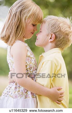 Stock Photo - Two young children hugging outdoors. Fotosearch