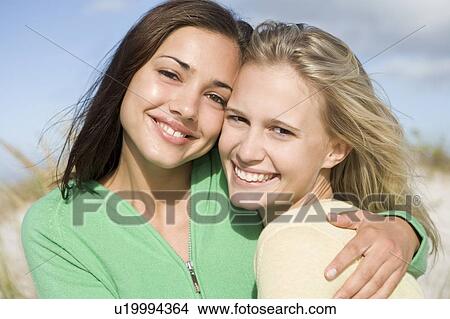 Two young women posing outdoors View Large Photo Image Picture - Two young women posing outdoors. Fotosearch