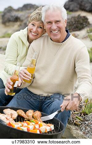 Couple Cooking On A Barbeque View Large Photo Image Stock Image - Couple Cooking On A Barbeque. Fotosearch