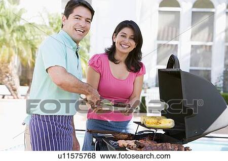 Stock Photo - Couple Cooking On A Barbeque. Fotosearch