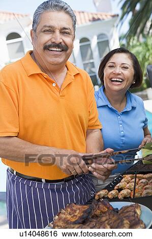 Couple Cooking On A Barbeque View Large Photo Image Stock Photograph - Couple Cooking On A Barbeque. Fotosearch