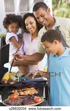 Family Enjoying A Barbeque View Large Photo Image Picture - Family Enjoying A Barbeque. Fotosearch