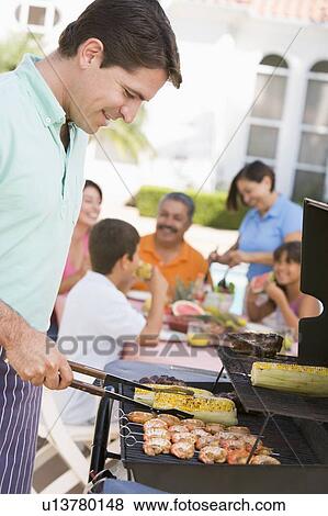 Family Enjoying A Barbeque View Large Photo Image Stock Photo - Family Enjoying A Barbeque. Fotosearch