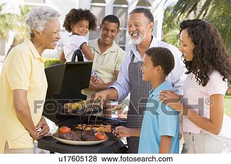 Stock Photo - Family Enjoying A Barbeque. Fotosearch
