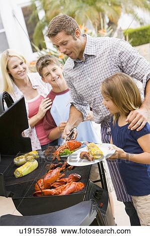 Family Enjoying A Barbeque View Large Photo Image Stock Photo - Family Enjoying A Barbeque. Fotosearch