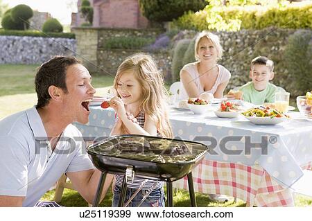 Family Enjoying A Barbeque View Large Photo Image Stock Photo - Family Enjoying A Barbeque. Fotosearch