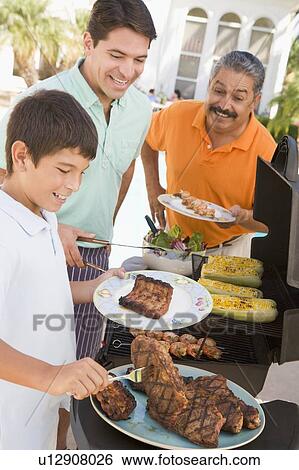 Stock Photograph - Family Enjoying A Barbeque. Fotosearch
