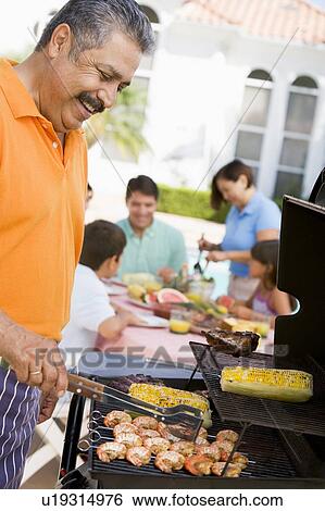 Stock Photograph - Family Enjoying A Barbeque. Fotosearch