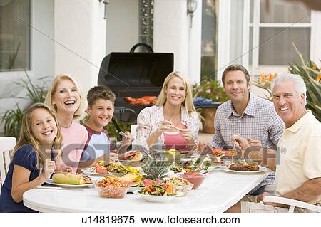 Stock Photography - Family Enjoying A Barbeque. Fotosearch