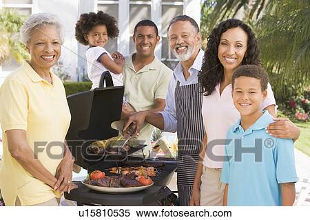 Stock Photography - Family Enjoying A Barbeque. Fotosearch