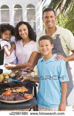 Stock Photography - Family Enjoying A Barbeque. Fotosearch