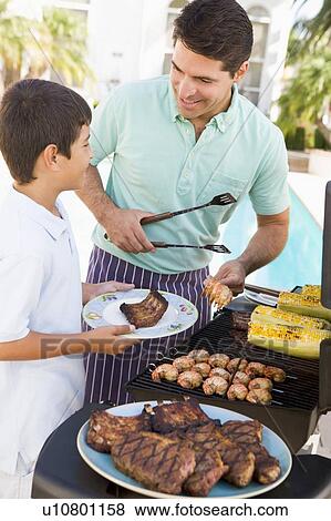 Father And Son Barbequing View Large Photo Image Stock Photo - Father And Son Barbequing. Fotosearch