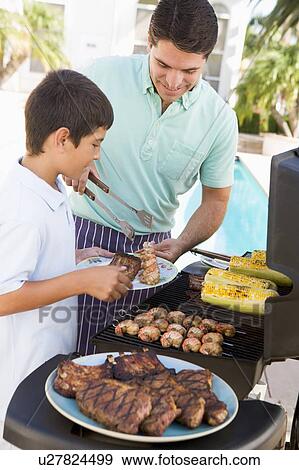 Stock Photo - Father And Son Barbequing. Fotosearch
