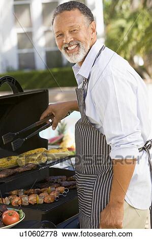Man Barbequing In A Garden View Large Photo Image Stock Photo - Man Barbequing In A Garden. Fotosearch
