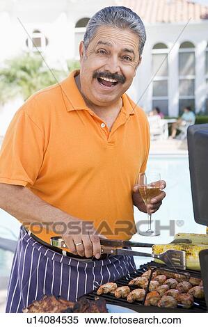 Stock Photography - Man Barbequing In A Garden. Fotosearch