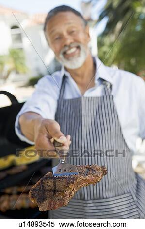 Man Barbequing In A Garden View Large Photo Image Stock Photography - Man Barbequing In A Garden. Fotosearch