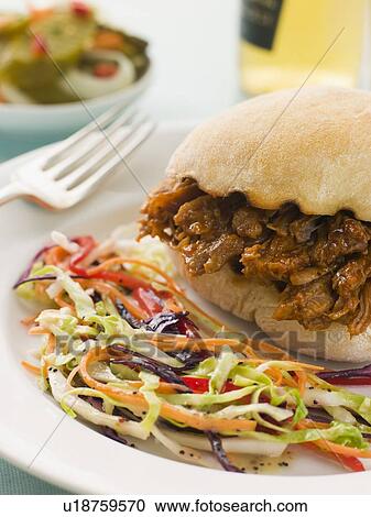 Pulled Pork and Barbeque Sauce Roll with Seeded Slaw and Gherkins View Large Photo Image Stock Image - Pulled Pork and Barbeque Sauce Roll with Seeded Slaw and Gherkins. Fotosearch