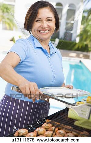 Woman Cooking On A Barbeque View Large Photo Image Stock Photo - Woman Cooking On A Barbeque. Fotosearch