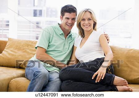 Couple in living room smiling View Large Photo Image Stock Image - Couple in living room smiling. Fotosearch