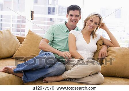 Couple in living room smiling View Large Photo Image Stock Image - Couple in living room smiling. Fotosearch