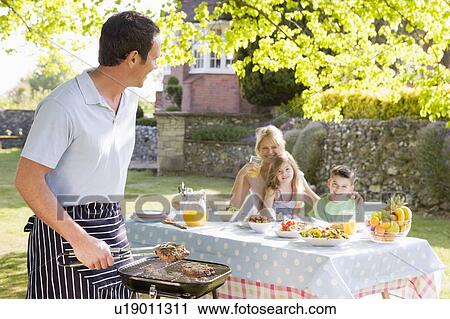 Family Enjoying A Barbeque View Large Photo Image Stock Image - Family Enjoying A Barbeque. Fotosearch