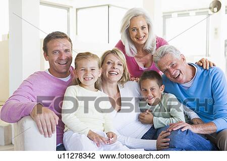 Family sitting indoors smiling View Large Photo Image Stock Image - Family sitting indoors smiling. Fotosearch